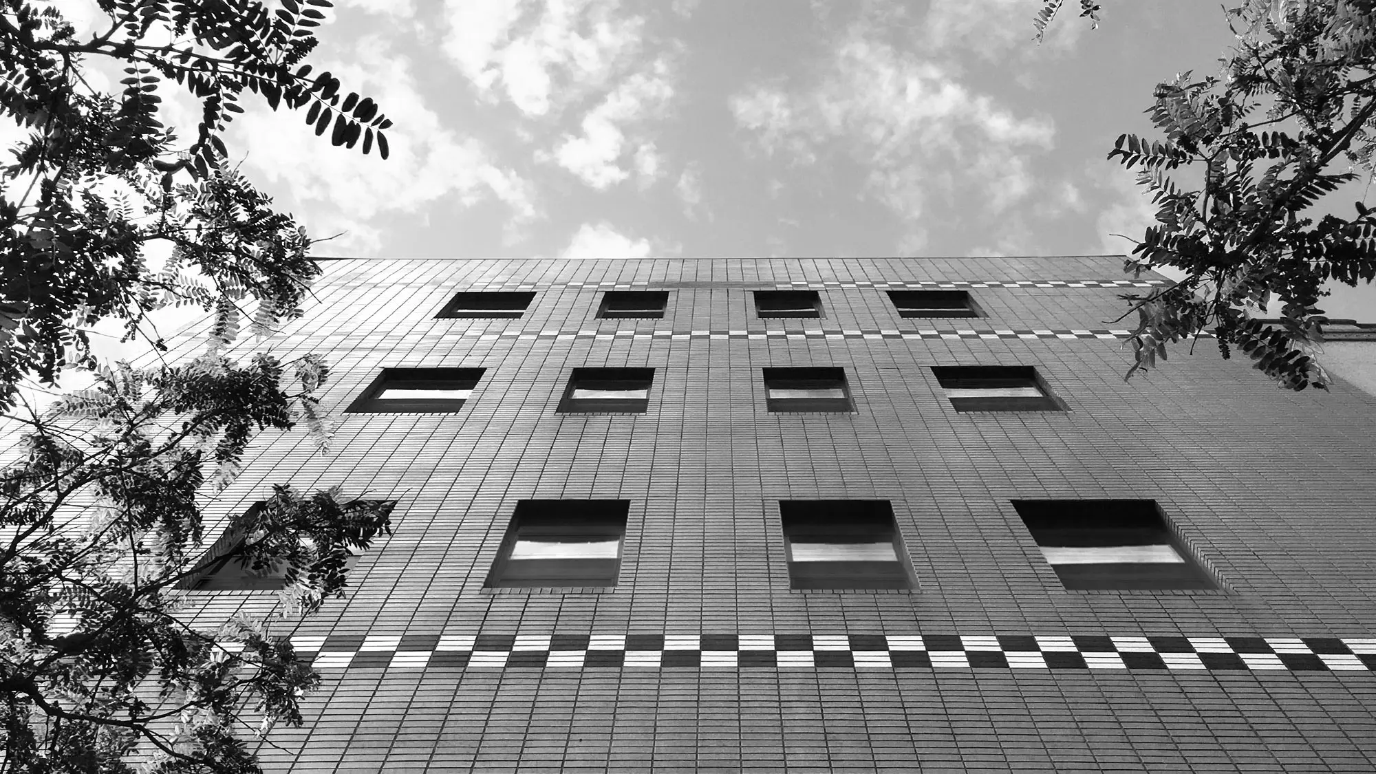 Exterior of Multiple Inc.’s headquarters featuring the unique checkerboard tile pattern