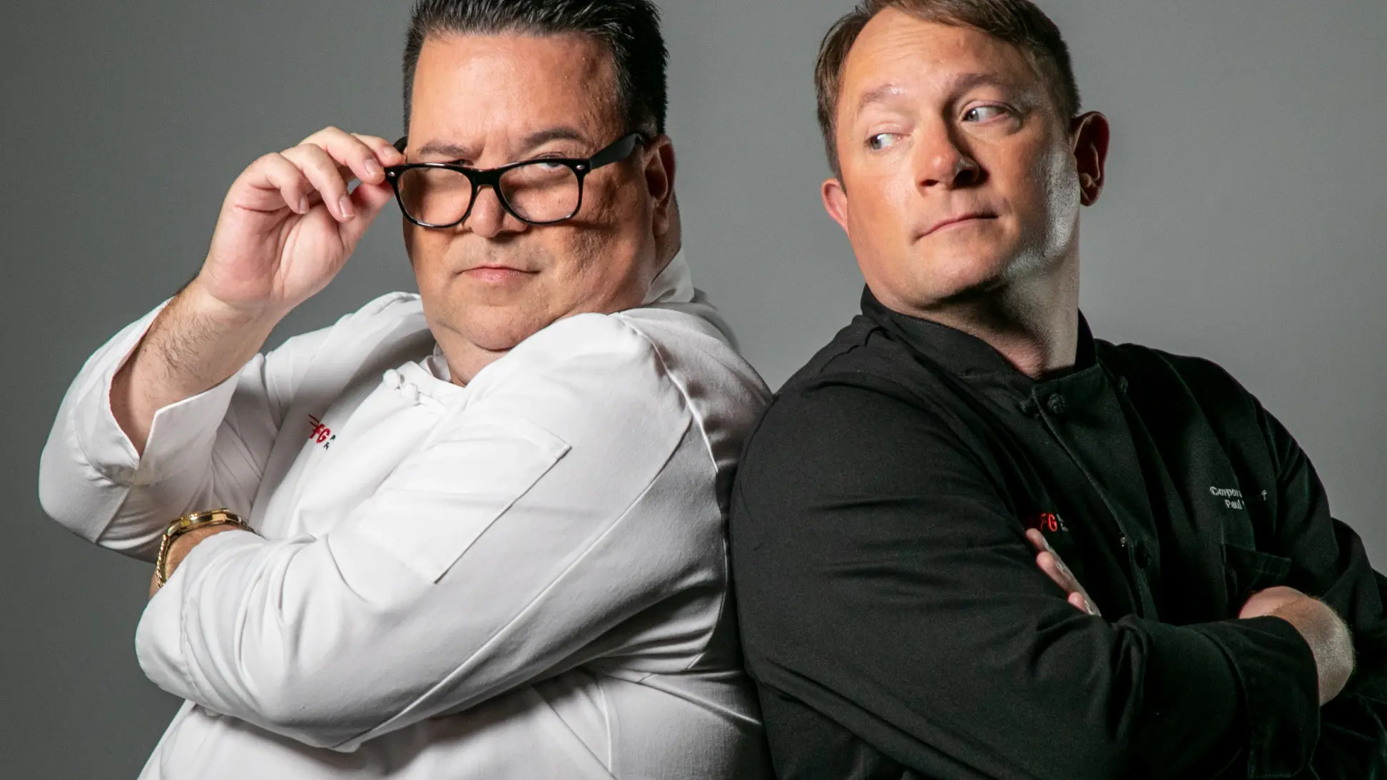 Chef Lonnie and Chef Paul standing back to back