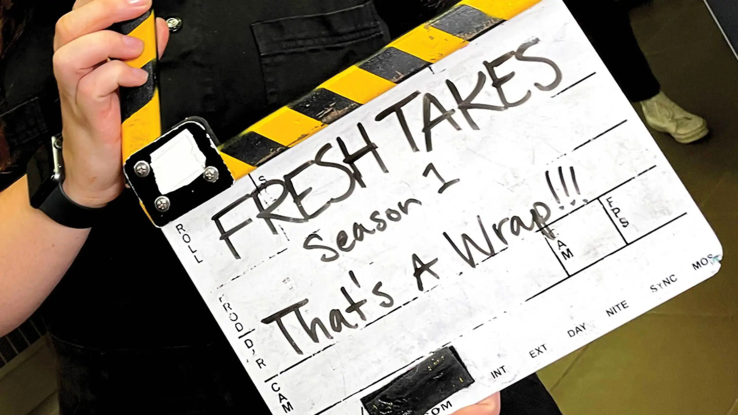 A video filming clipboard that says, “FreshTakes, Season 1, That’s a wrap!”
