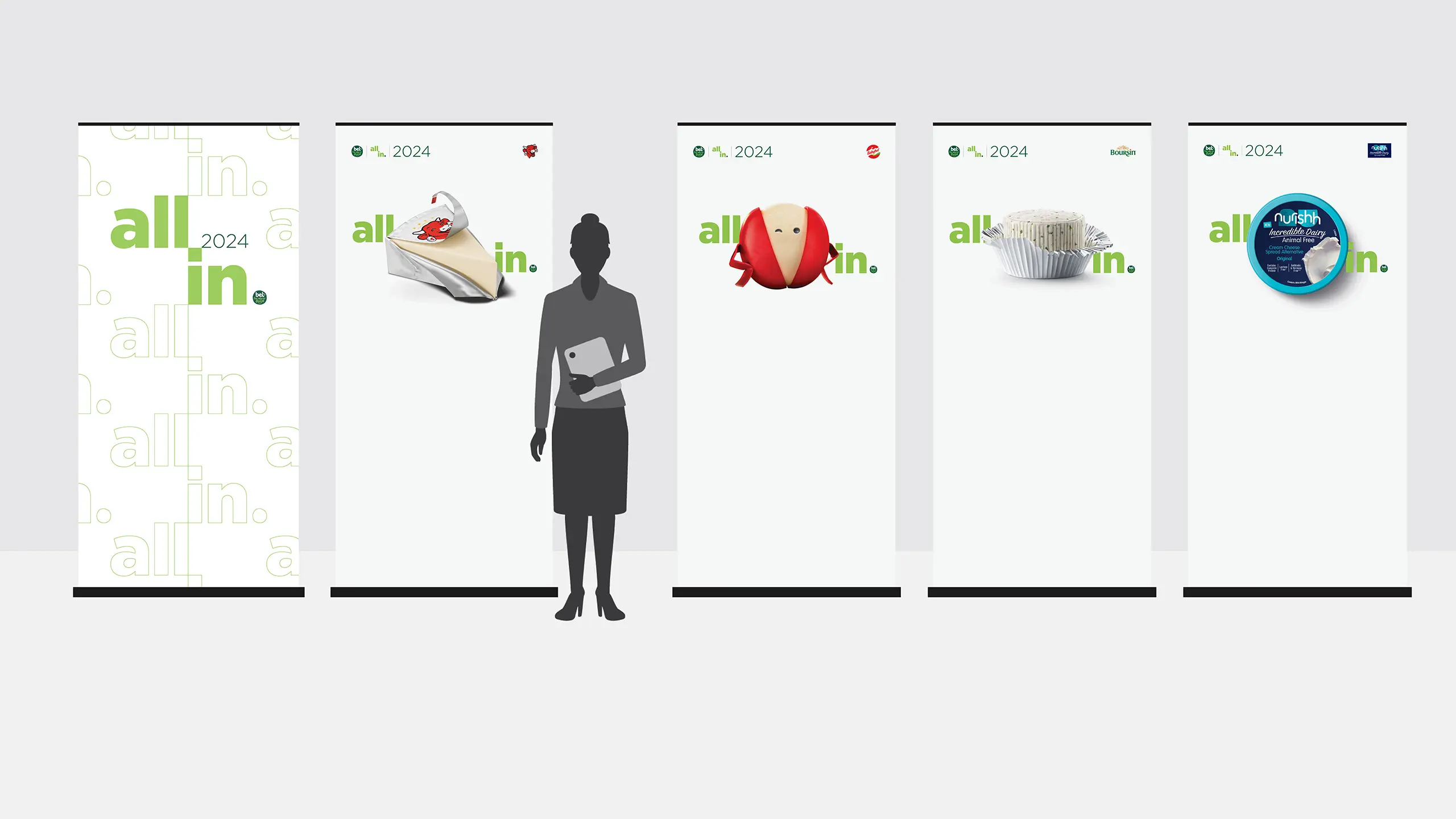 Five Pop-up banners reading ‘All In 2024,’ featuring Bel Brands cheese products, shown at human scale with a silhouetted person for size reference
