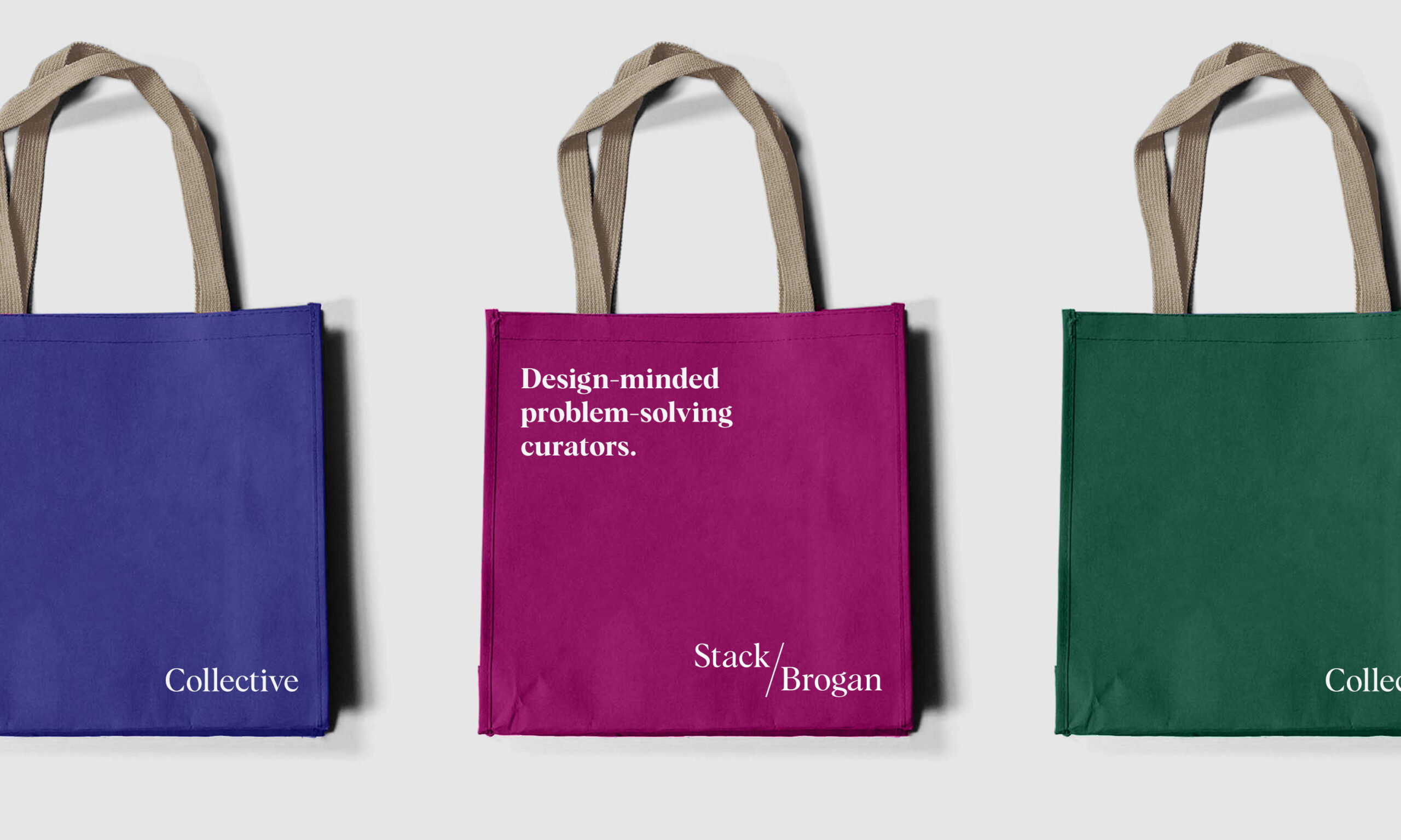 Three tote bags with beige handles are aligned horizontally. From left to right: a blue bag with “Collective,” a pink bag with “Design-minded problem-solving curators. Stack/Brogan,” and a green bag with “Collective.”