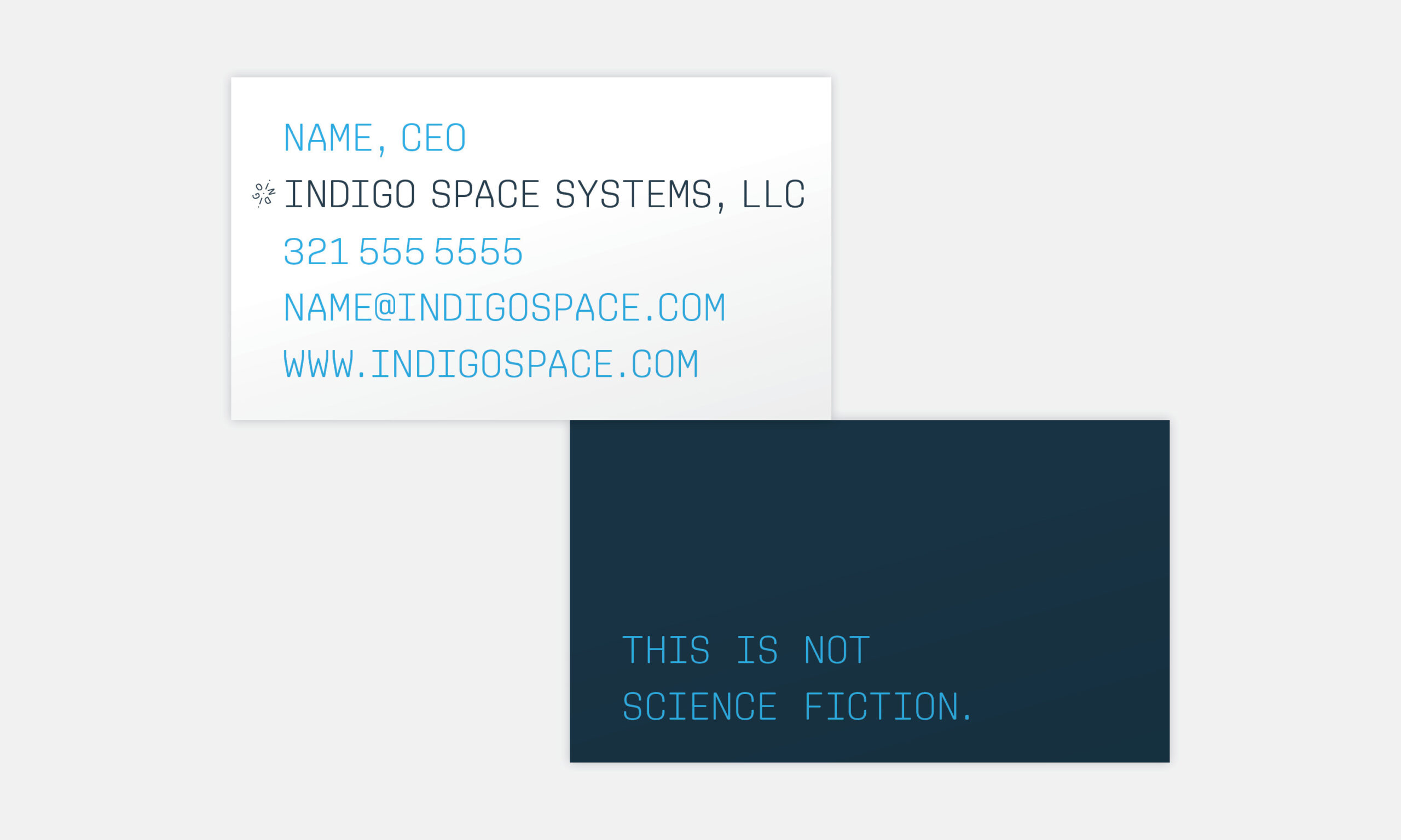 Business card with text. Front: "Name, CEO, Indigo Space Systems, LLC," contact info in blue. Back: Dark blue with "This is not science fiction."