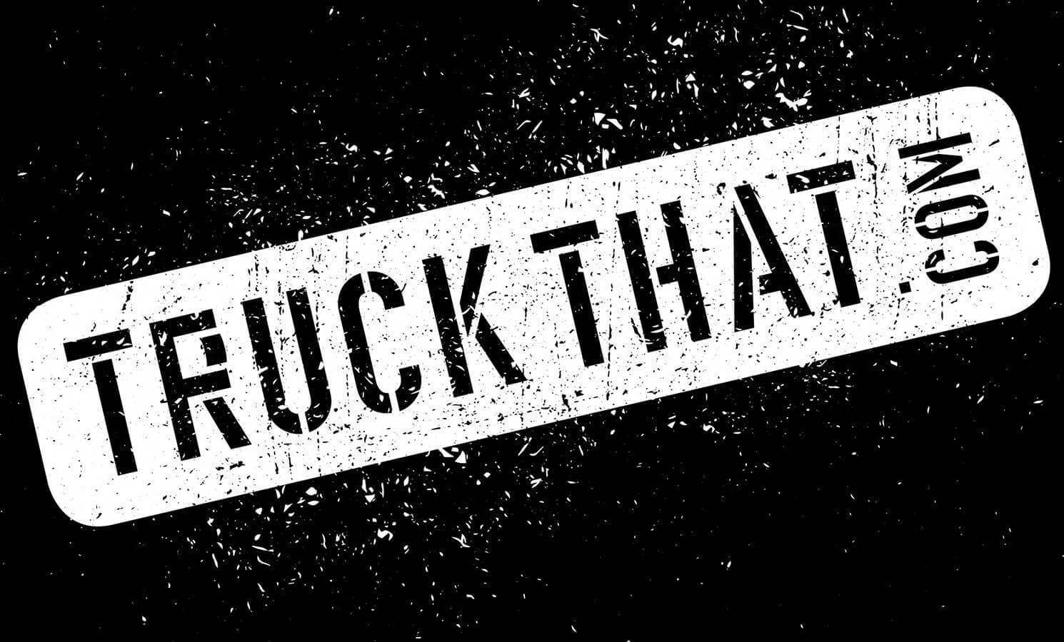 White, distressed text on an angle saying "TRUCK THAT .COM" on a black, grunge background.