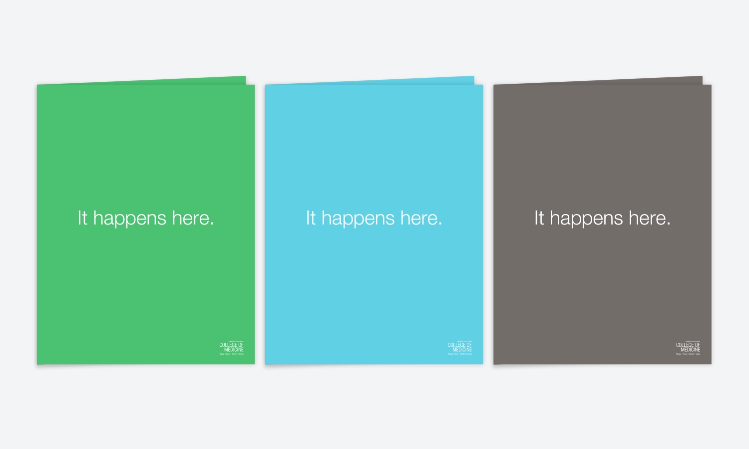 Three pocket folders side by side: green, blue, and gray, each with the phrase "It happens here." in white text, college logo bottom right.